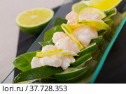 Ceviche from alaska pollock on a glass plate with lime and herbs. Стоковое фото, фотограф Яков Филимонов / Фотобанк Лори