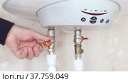 Plumber is connecting boiler to domestic water supply system. Стоковое видео, видеограф Владимир Григорьев / Фотобанк Лори