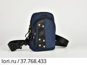 A small shoulder bag for documents and small items on a white background. A must have accessory for travel. Стоковое фото, фотограф Андрей Никитин / Фотобанк Лори