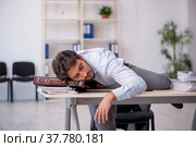 Young male employee in oversleeping concept. Стоковое фото, фотограф Elnur / Фотобанк Лори