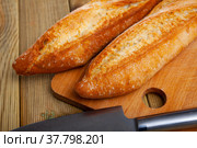 French loaves on wooden surface. Стоковое фото, фотограф Яков Филимонов / Фотобанк Лори