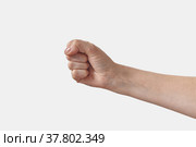 Female hand with manicure in fist on white. Стоковое фото, фотограф Ярослав Данильченко / Фотобанк Лори