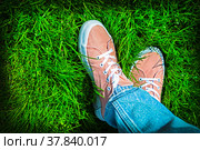 Ноги девушки в розовых кедах на фоне зеленой лужайки. Стильный, модный яркий летний фон. Радуемся лету, теплу, ярким краскам. В парке, непринужденная удобная обувь и стиль одежды, свобода, непосредственность. Фон, обои, открытка. Стоковое фото, фотограф Ludmila Zyubina / Фотобанк Лори