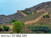 Medieval fortress wall and tower on a mountain slope, Shamil (Gunib) fortress in Dagestan. Стоковое фото, фотограф Евгений Харитонов / Фотобанк Лори