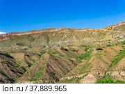 Mountain landscape with a huge geological fault, a canyon wall with cliffs, screes and alluvial fans. Стоковое фото, фотограф Евгений Харитонов / Фотобанк Лори