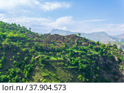 Ruins of houses on a mountainside in Kurib, a depopulated village with the only remaining household with an apiary, Dagestan. Стоковое фото, фотограф Евгений Харитонов / Фотобанк Лори