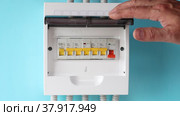 User switches circuit breaker of fuse box in distribution panel of consumer unit. Стоковое видео, видеограф Владимир Григорьев / Фотобанк Лори