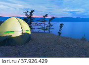 Baikal Lake on a summer evening. Tourist tent on the bank of Olkhon Island. View of the Small Sea Strait at sunset. Summer travel. Стоковое фото, фотограф Виктория Катьянова / Фотобанк Лори