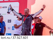 Член экипажа команды Nakusi Racing Team Кирилл Шубин, завоевавший серебряную медаль в категории мотовездеходов во время торжественной церемонии награждения участников международного ралли "Шелковый путь" в "Лужниках" (2022 год). Редакционное фото, фотограф Николай Винокуров / Фотобанк Лори