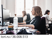 Yound devoted female software developers team working on desktop computer in IT statup company. Стоковое фото, фотограф Matej Kastelic / Фотобанк Лори