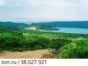 Natural landscape of Kunashir island, view of the Golovnin volcano caldera with hot lakes and a path through the thickets of sasa and dwarf pines on a foreground. Стоковое фото, фотограф Евгений Харитонов / Фотобанк Лори