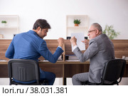 Two male employees working in the office. Стоковое фото, фотограф Elnur / Фотобанк Лори