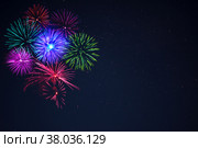 Pink purpe blue green fireworks over night sky. Стоковое фото, фотограф TasiPas / Фотобанк Лори