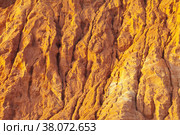 Natural background of erosion of clay sandstone rocks under the influence of sea wind and precipitation. Natural phenomena. Bright texture of decaying soil. Стоковое фото, фотограф Виктория Катьянова / Фотобанк Лори