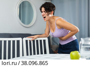 Young woman holding hands on the illness stomache. Стоковое фото, фотограф Яков Филимонов / Фотобанк Лори