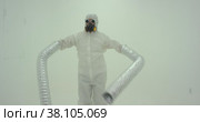 Strange silhouette of man in chemical protection suite with very long sleeves. Стоковое видео, видеограф Aleksey Kidisyuk / Фотобанк Лори