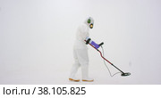 Man in white chemical protection suit holds metal detector. Стоковое видео, видеограф Aleksey Kidisyuk / Фотобанк Лори
