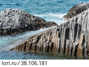 Rocky seashore formed by columnar basalt against the surf, coastal landscape of the Kuril Islands. Стоковое фото, фотограф Евгений Харитонов / Фотобанк Лори
