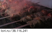Close-up of lumpy kebab with tomato and ground kebab is grilled on the grill. Стоковое видео, видеограф Aleksey Kidisyuk / Фотобанк Лори