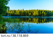 Beaitiful landscape of Lake Haukivesi during sunrise. Light fog over the water. Specular reflection in the water.  Saimaa lake system, Rantasalmi, Savo, Finland. Стоковое фото, фотограф Михаил Аккуратoв / Фотобанк Лори