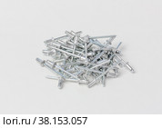 Rivets for the riveter or manual and electric rivet gun on a gray background. Стоковое фото, фотограф Андрей С / Фотобанк Лори
