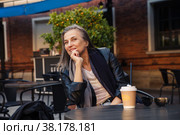 Well-groomed gray-haired woman of 60 years old at cafe table with coffee. Стоковое фото, фотограф Дарья Трофимова / Фотобанк Лори