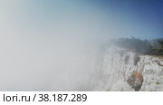 A cliff on the cliff, over which the fog cannot rise. Free space for a logo or text. Drone aerial shot. Стоковое видео, видеограф Даниил Хабаров / Фотобанк Лори