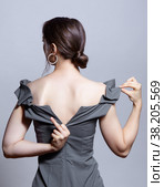 Young woman unzips the zipper on the dress. Hand showing fuck sign. Стоковое фото, фотограф Сергей Пристяжнюк (Serg Zastavkin) / Фотобанк Лори