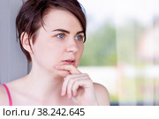 Portrait of a girl, thoughtfully putting her finger to her chin. Стоковое фото, фотограф Татьяна Дворецкая / Фотобанк Лори