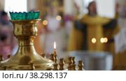 Candles burn in a lamp in an Orthodox church - a session of worship on the background. Стоковое видео, видеограф Константин Шишкин / Фотобанк Лори