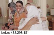RUSSIA, KAZAN 08-28-2022: women in the Orthodox Church - an old woman holds a baby. Редакционное видео, видеограф Константин Шишкин / Фотобанк Лори