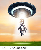 The flying saucer abducting young businessman. Стоковое фото, фотограф Elnur / Фотобанк Лори