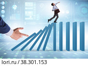Businessman in domino effect concept. Стоковое фото, фотограф Elnur / Фотобанк Лори