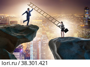 Business people helping to go over chasm. Стоковое фото, фотограф Elnur / Фотобанк Лори