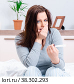 Young woman finding out about her pregnancy. Стоковое фото, фотограф Elnur / Фотобанк Лори