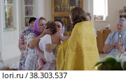 RUSSIA, KAZAN 08-28-2022: priest puts a cross on a baptized baby in church. Редакционное видео, видеограф Константин Шишкин / Фотобанк Лори