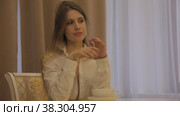 Girl actress of Slavic appearance in white shirt shows her emotions. Стоковое видео, видеограф Aleksandr Golubev / Фотобанк Лори