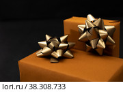 Presents packed and decorated on black background. Стоковое фото, фотограф Юлия Паутова / Фотобанк Лори