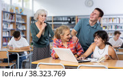 Mature female teacher asks the amused schoolchildren to behave a little quieter. Стоковое фото, фотограф Яков Филимонов / Фотобанк Лори
