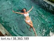 Young slim woman in swimsuit swims in swimming pool. Стоковое фото, фотограф Aleksandr Golubev / Фотобанк Лори