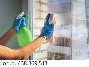 Cleaning window pane with detergent, spring cleaning concept. Стоковое фото, фотограф Вербицкая Светлана / Фотобанк Лори