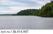 The landscape of the coastline of the island of Valaam, overgrown with forest, on a cloudy day (2021 год). Редакционное фото, фотограф Михаил Аккуратoв / Фотобанк Лори