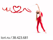 Isolated on white background Gymnast in red suit is exercising with ribbon, the ribbon is twisted in heart. Стоковое фото, фотограф Мария Мороз / Фотобанк Лори