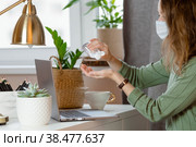 Коронавирус и грипп. Деловая женщина, работающая в офисе в защитной маске. Деловая женщина на карантине из-за коронавируса в защитной маске. Работа из дома. Моет руки дезинфицирующим гелем. Стоковое фото, фотограф Photojuli / Фотобанк Лори