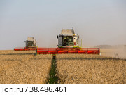 Russia, Kazan - august 5, 2020 : Claas Combine Harvester harvesting a crop of Barley. Редакционное фото, фотограф Ольга Сейфутдинова / Фотобанк Лори