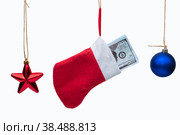 Lot of dollars in a Christmas sock and Christmas tree toys on a white background isolated. Стоковое фото, фотограф Ярославский Максим / Фотобанк Лори