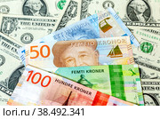 Banknotes of Swedish and Norwegian kronor on the background of American dollars. Стоковое фото, фотограф FotograFF / Фотобанк Лори