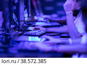 Group of guys collectively play an online game in a competition in blue lighting - esports. Стоковое фото, фотограф Константин Шишкин / Фотобанк Лори