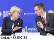 Russia. Saint-Petersburg. XXIII St. Petersburg International Economic Forum 2019. SPIEF 2019 participants. Olga Golodets, a Russian politician, economist, Deputy Prime Minister of the Russian Federation, and Pyotr Ivanov, a Russian specialist in the field of transport management, General Director of Federal Passenger Company JSC. Россия. Санкт-Петербург. XXIII Петербургский международный экономический форум 2019. Участники ПМЭФ-2019. Российский политик, экономист, заместитель председателя правительства Российской Федерации Ольга Голодец и российский специалист в области управления транспортом, генеральный директор АО Федеральная пассажирская компания Петр Иванов. Редакционное фото, фотограф Алексей Смышляев / Фотобанк Лори