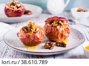 Whole baked apples with honey and walnuts on a plate. Homemade dessert. Стоковое фото, фотограф Елена Руй / Фотобанк Лори
